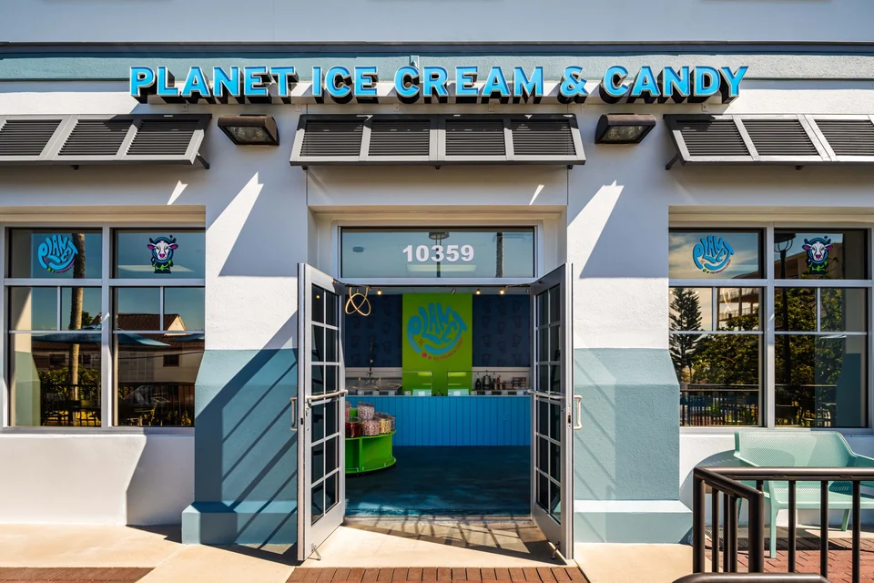 The open entrance to Planet Ice Cream & Candy beneath the blue storefront sign, with address 10359 above the door.